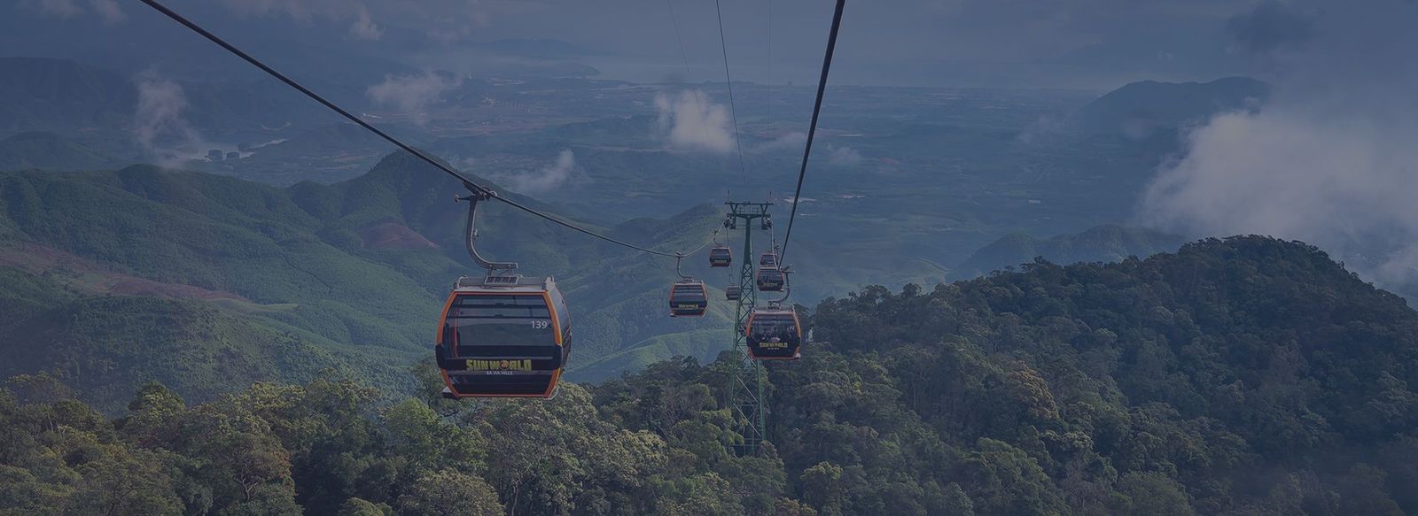 Cable cars over forested hills